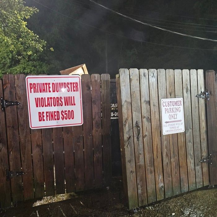 Wooden gate with signs: 