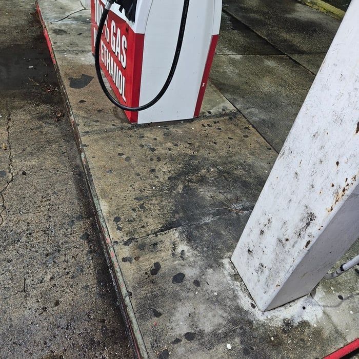 Gas pump and concrete surface with stains.