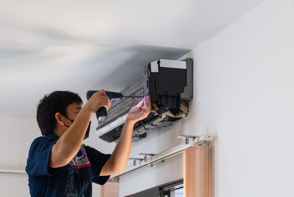 Air Conditioning Repair, Repairman fixing air conditioning system