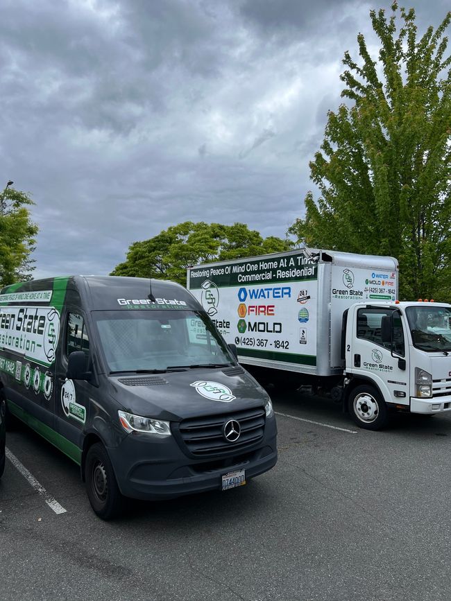 Two trucks are parked next to each other in a parking lot.