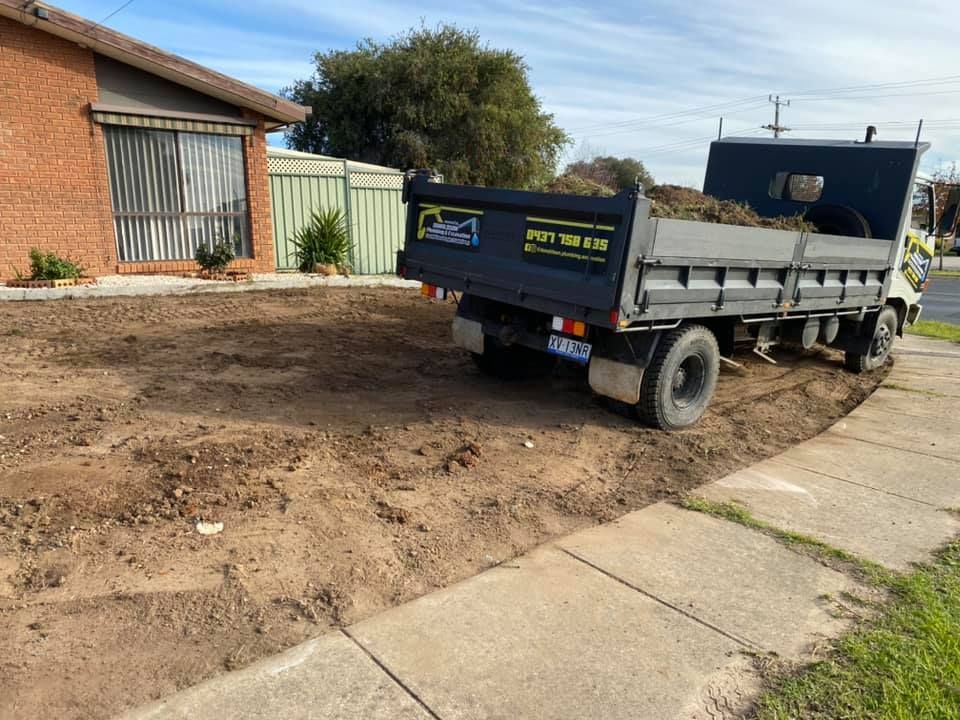 Dump Truck is Parked on the Side of the Road in Front of a House — Donaldson Plumbing & Excavations in Kiewa, VIC