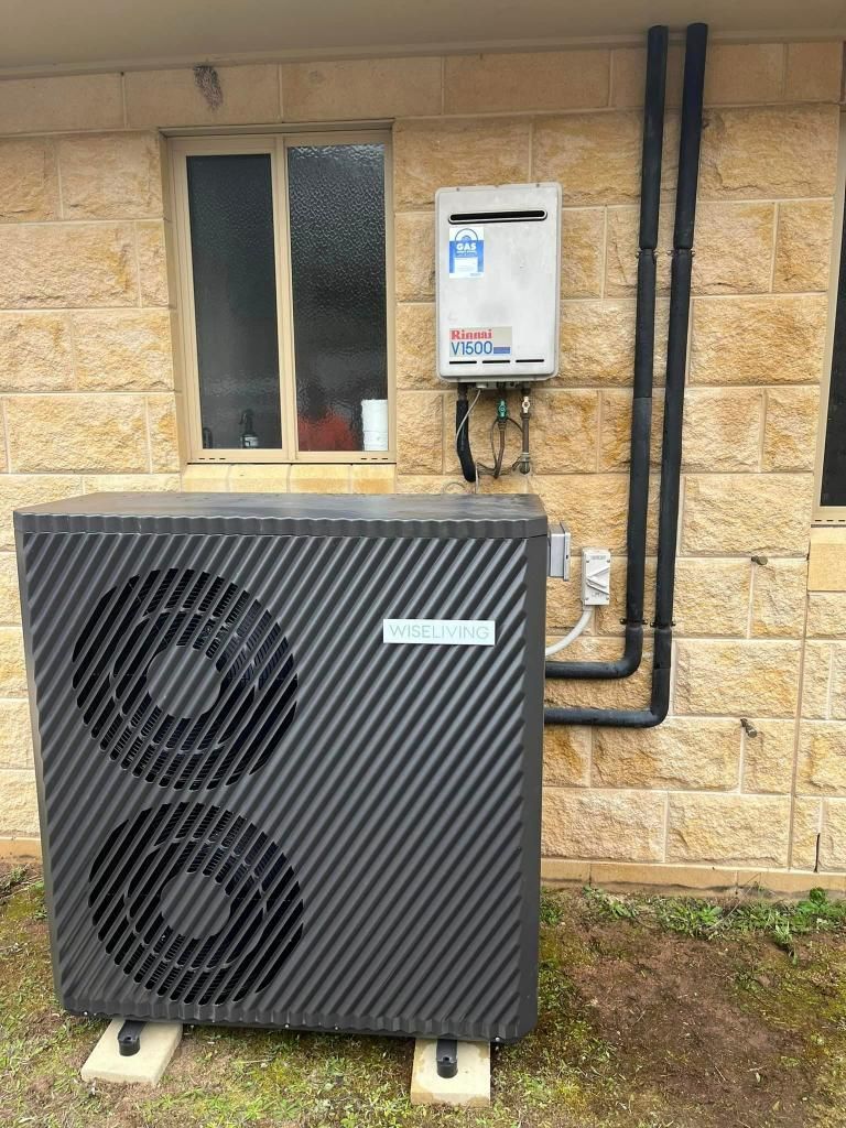 Large Black Air Conditioner is Sitting Outside — Donaldson Plumbing & Excavations in Wodonga, VIC