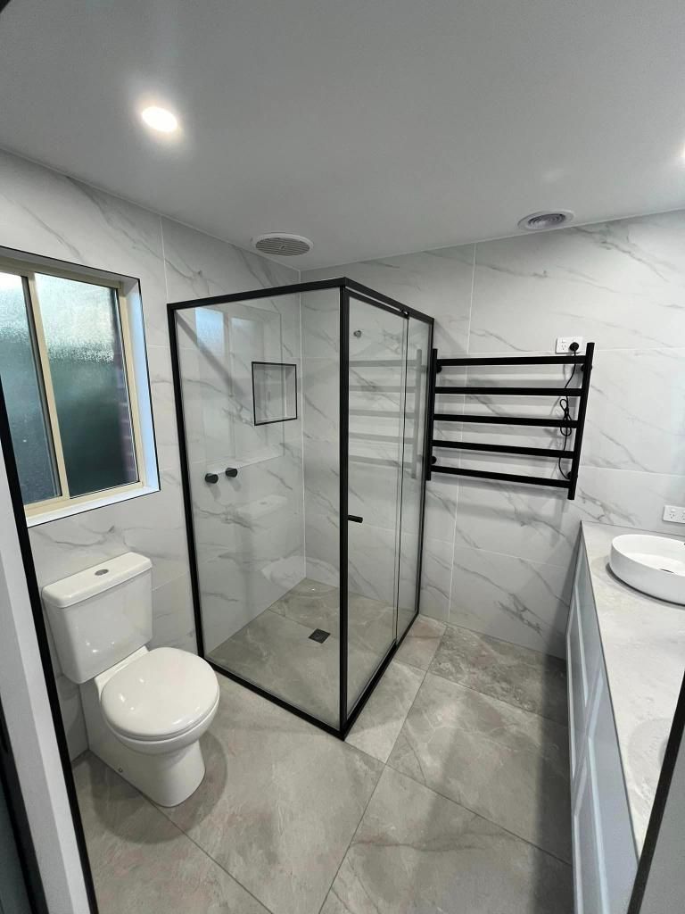 Bathroom With a Toilet , Sink and Shower Stall — Donaldson Plumbing & Excavations in Kiewa, VIC
