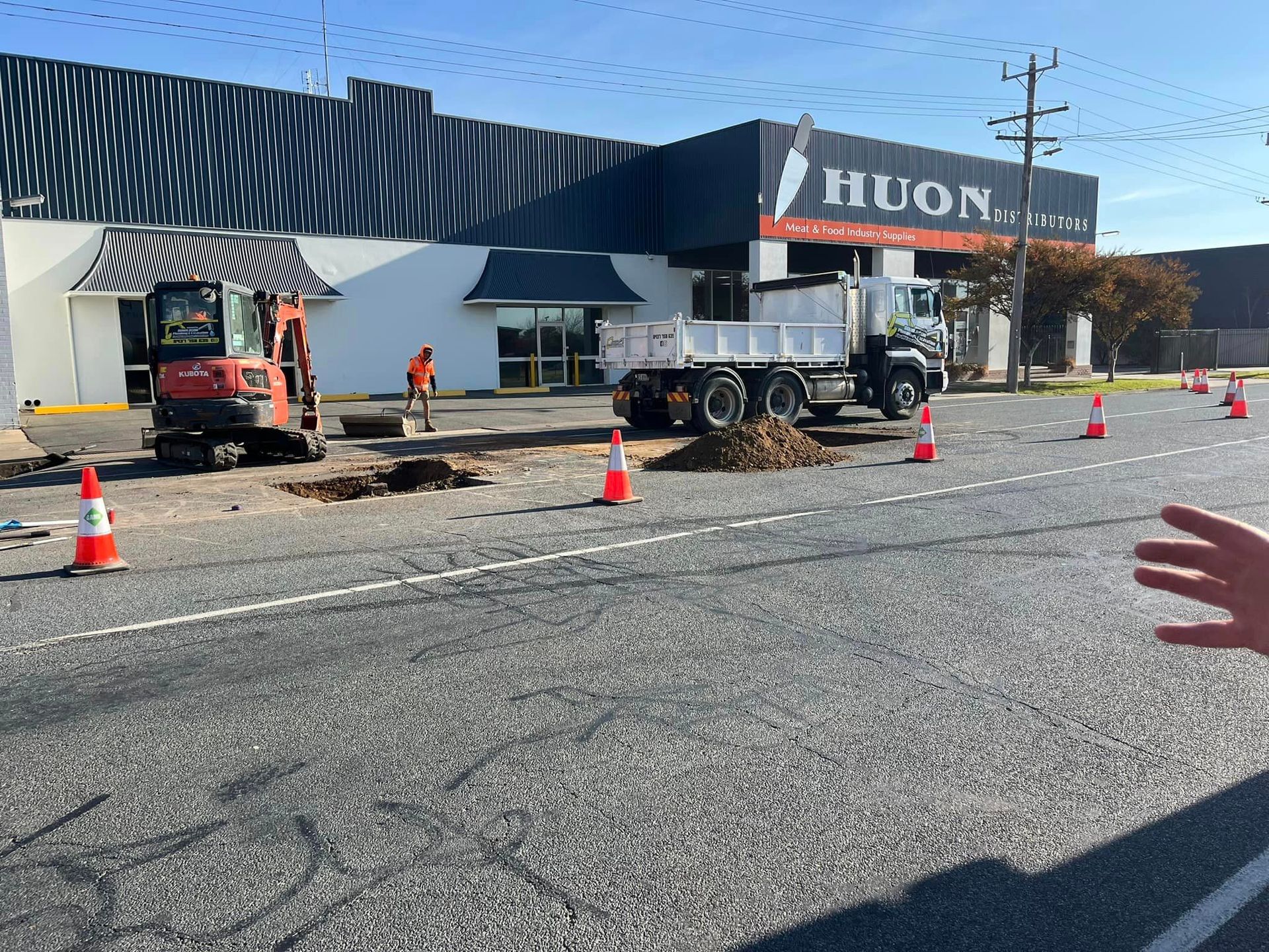 Toilet in a Bathroom Next to a Soap Dispenser — Donaldson Plumbing & Excavations in Chiltern, VIC