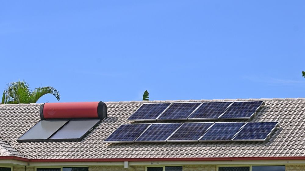 Solar Panels and a Water Heater on a Tiled Roof — Donaldson Plumbing & Excavations in Wodonga, VIC