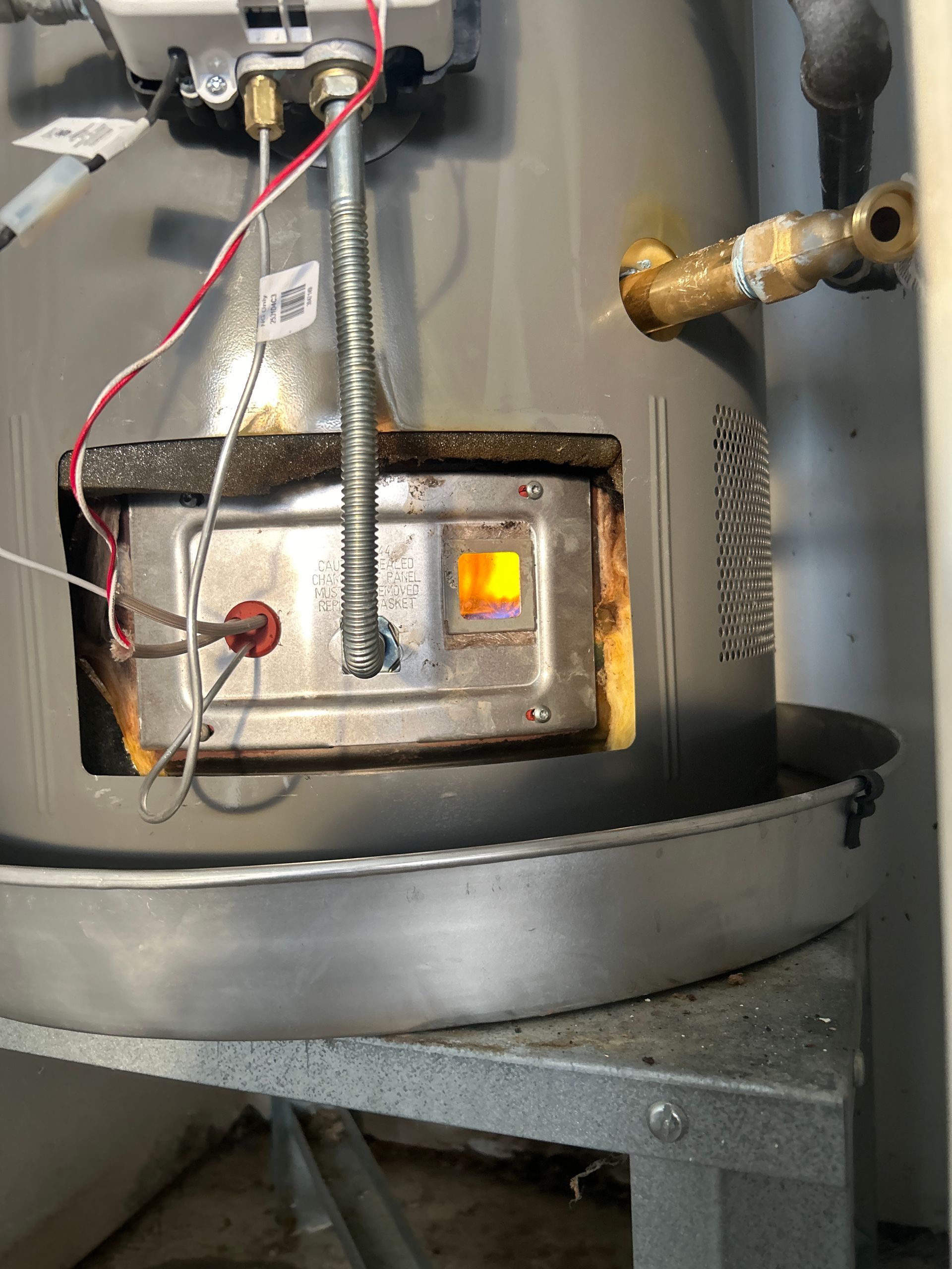 Gas water heater with pilot light lit.
