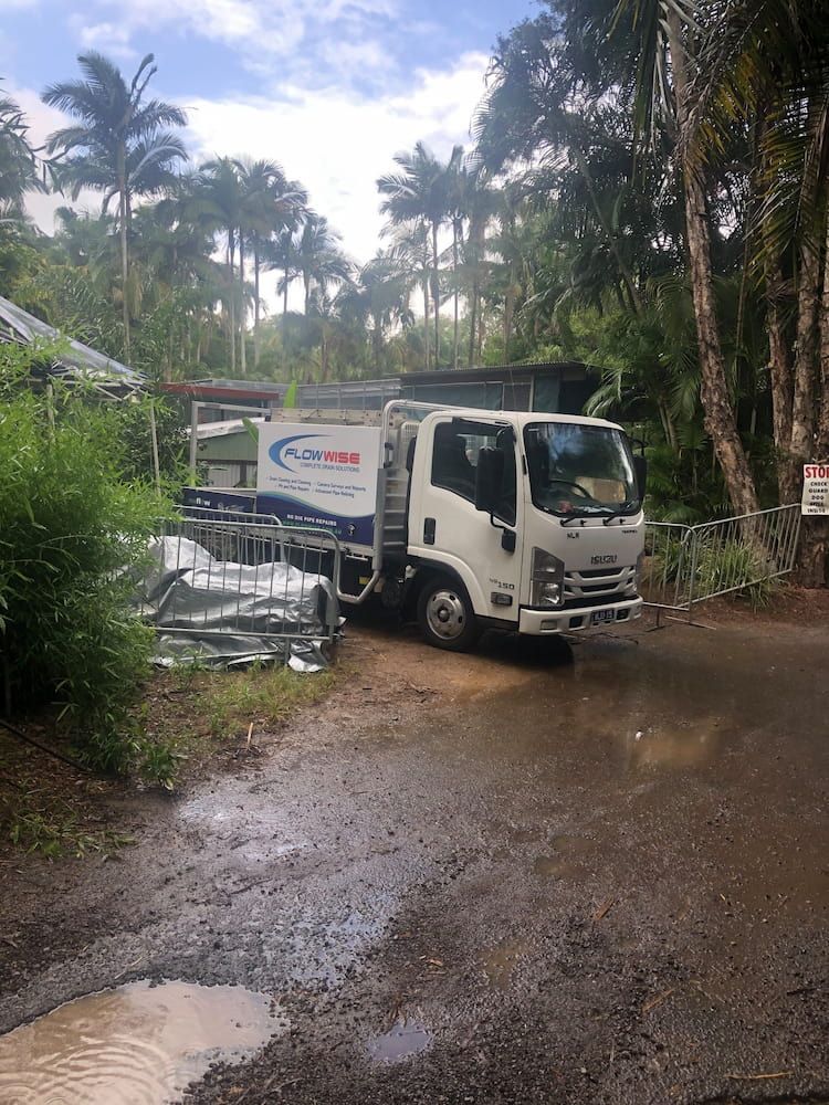 A White Truck is Parked on the Side of a Dirt Road — FlowWise in Maroochydore, QLD