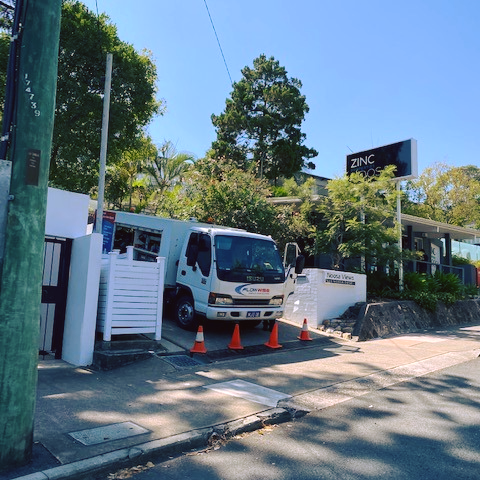A White Truck is Parked in Front of a Building That Says Zinc — FlowWise in Maroochydore, QLD