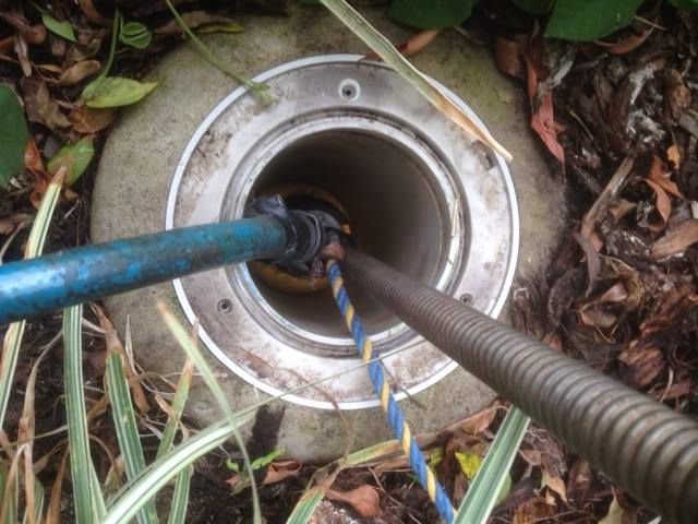 A Hose is Being Used to Clean a Septic Tank — FlowWise in Buderim, QLD