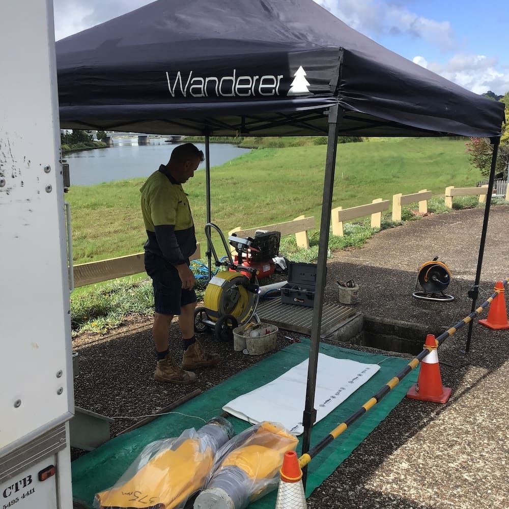 A Man is Standing Under a Tent That Says Wanderer — FlowWise in Maroochydore, QLD