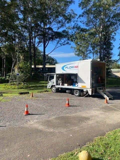 A White Moving Truck is Parked in a Parking Lot — FlowWise in Maroochydore, QLD
