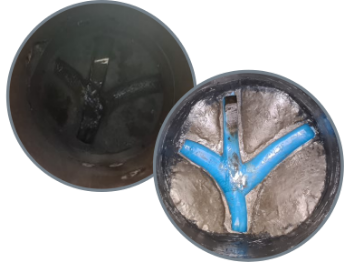 Two open, dark-colored, circular objects, one showing a black interior, the other revealing a blue, Y-shaped structure inside.