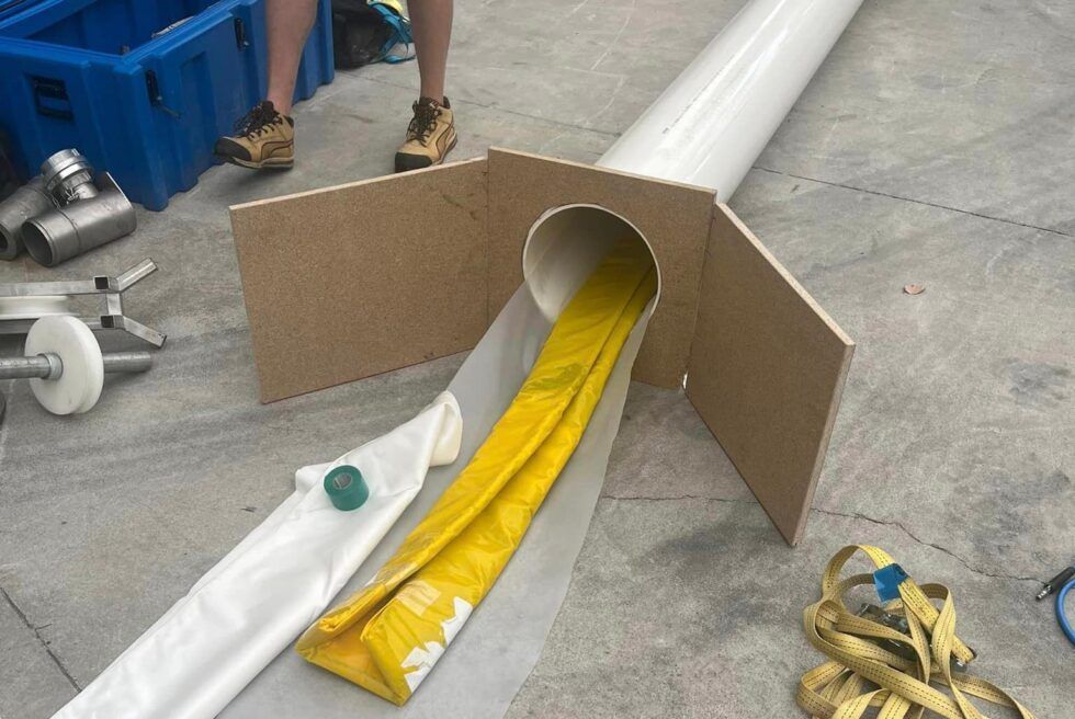 A Yellow Hose is Coming Out of a Pipe on the Ground — FlowWise in Maroochydore, QLD