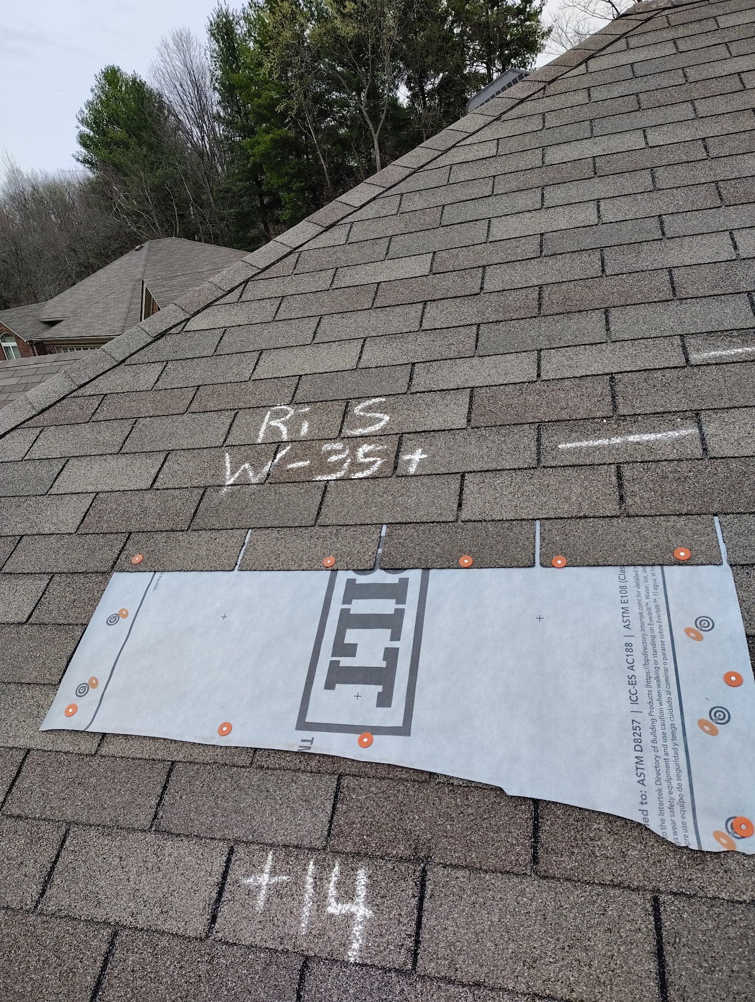 A piece of paper is laying on top of a roof.