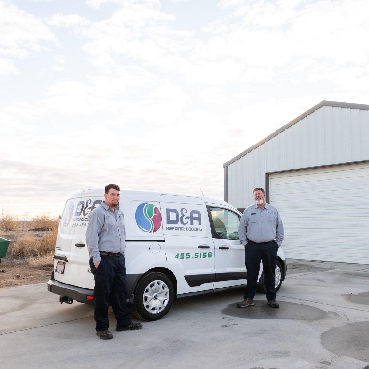 Two men are standing in front of a dca van