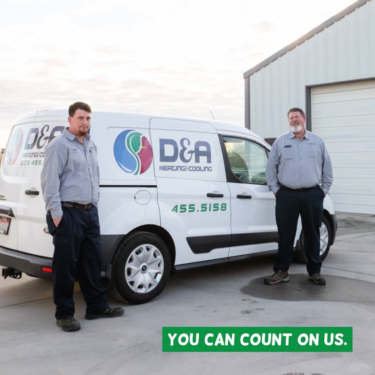 Two men standing in front of a d & a van