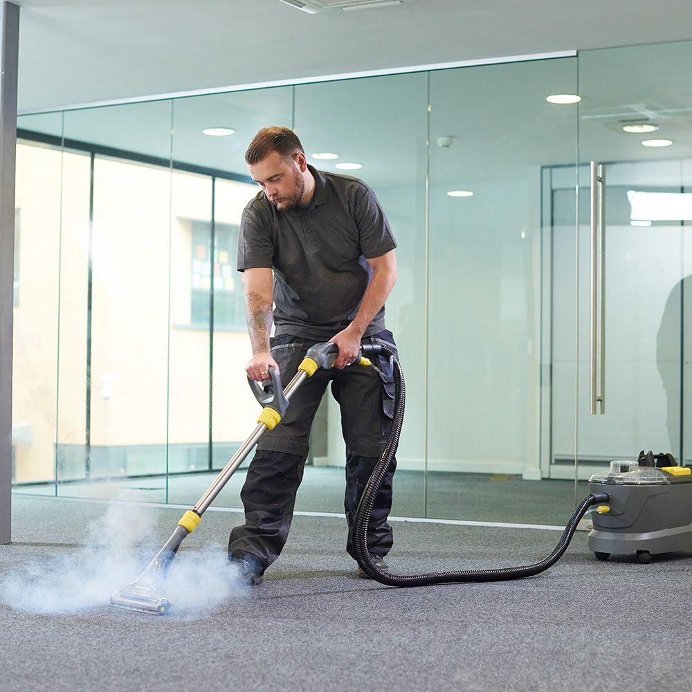 Male Steam Cleans an Office Carpet — Elizabeth, NJ — Omega Maintenance Corp