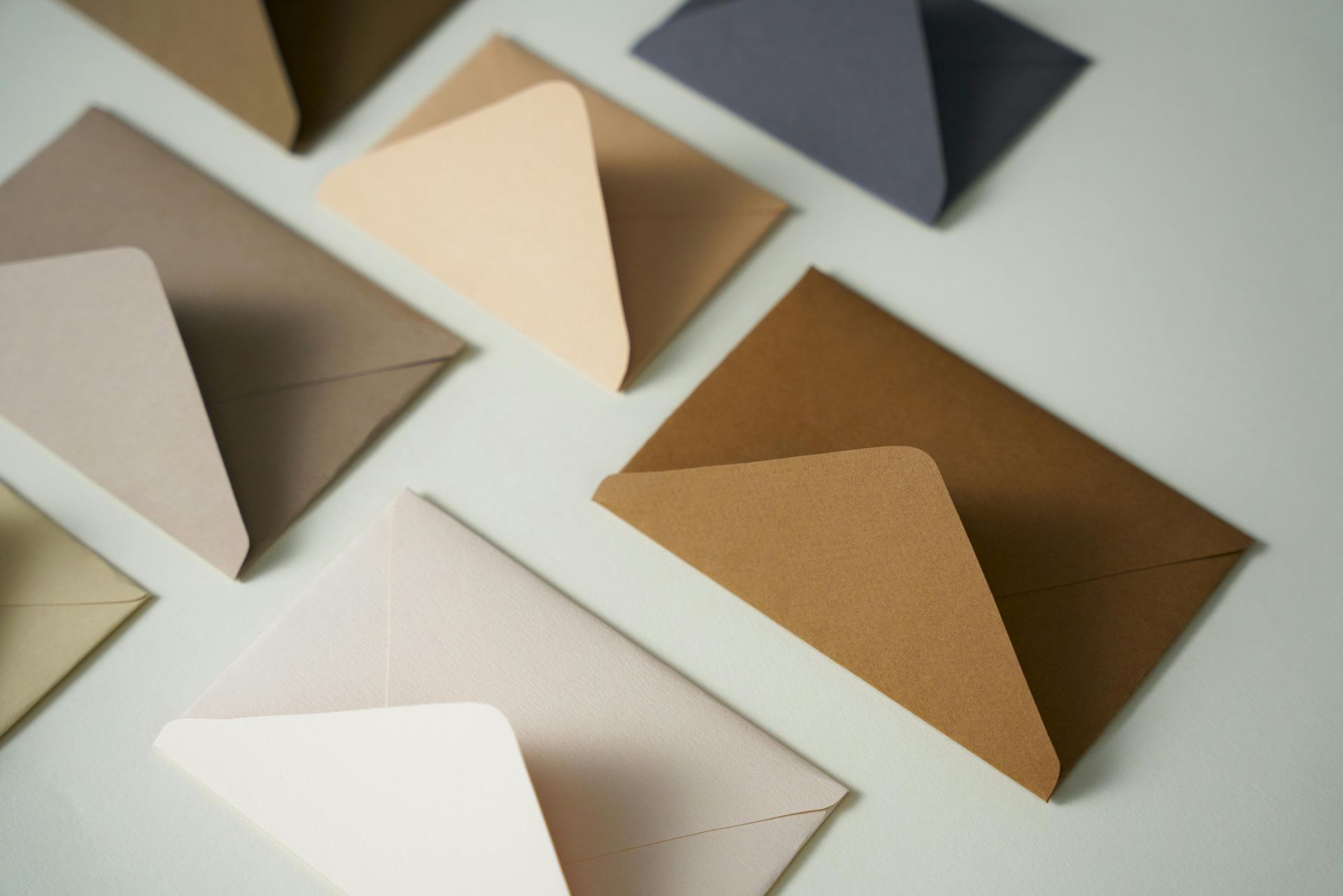 A bunch of different colored envelopes on a table