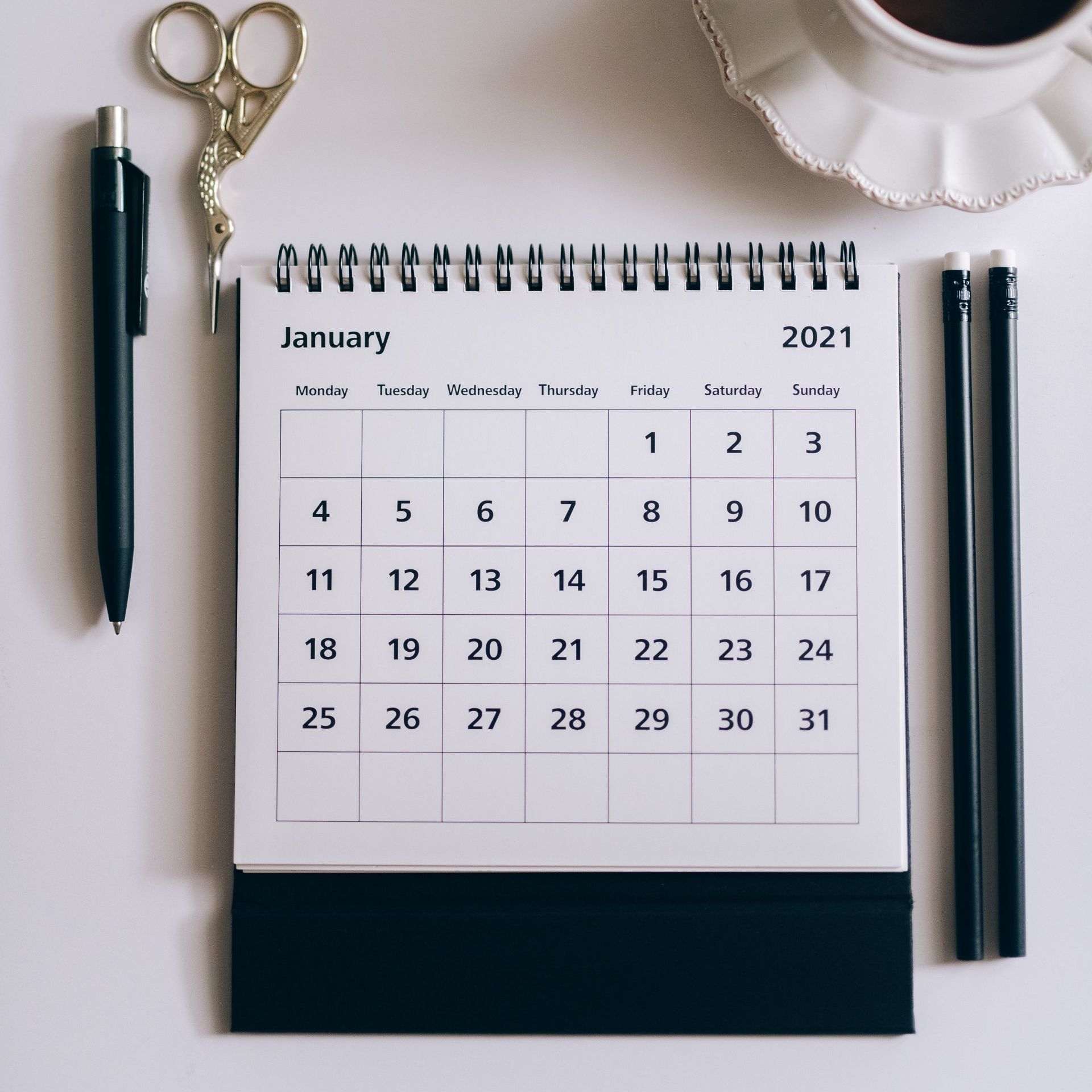 A calendar for january 2021 sits on a table