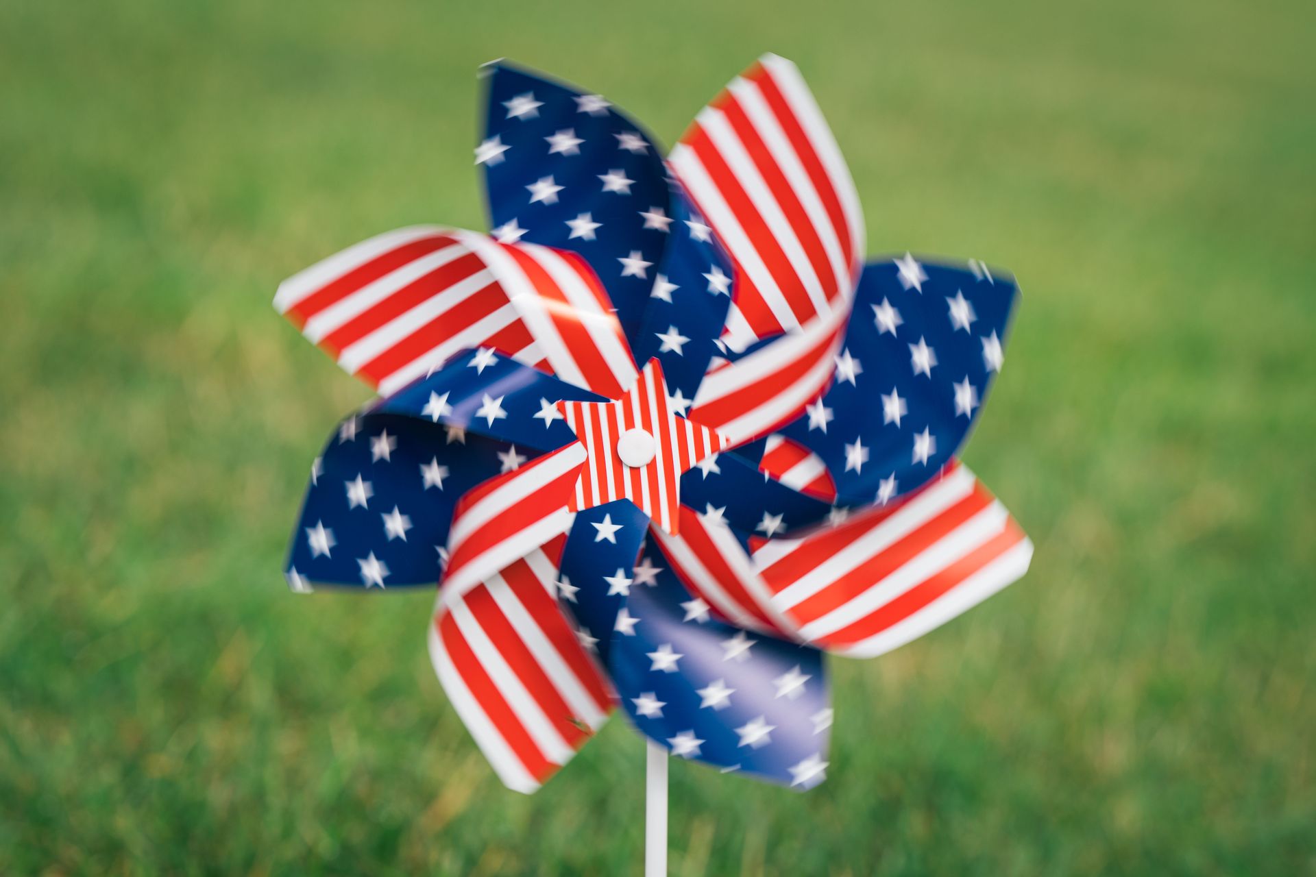 American flag pinwheel on a green lawn