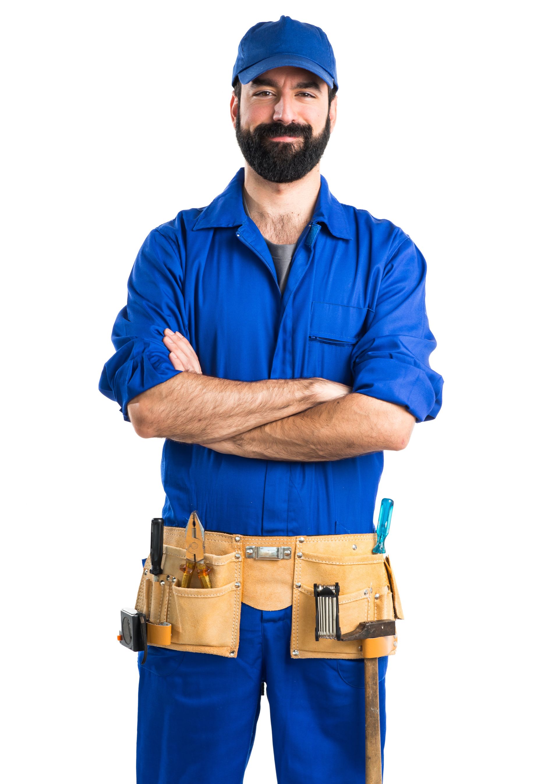 A man in a blue jumpsuit and hat is standing with his arms crossed.