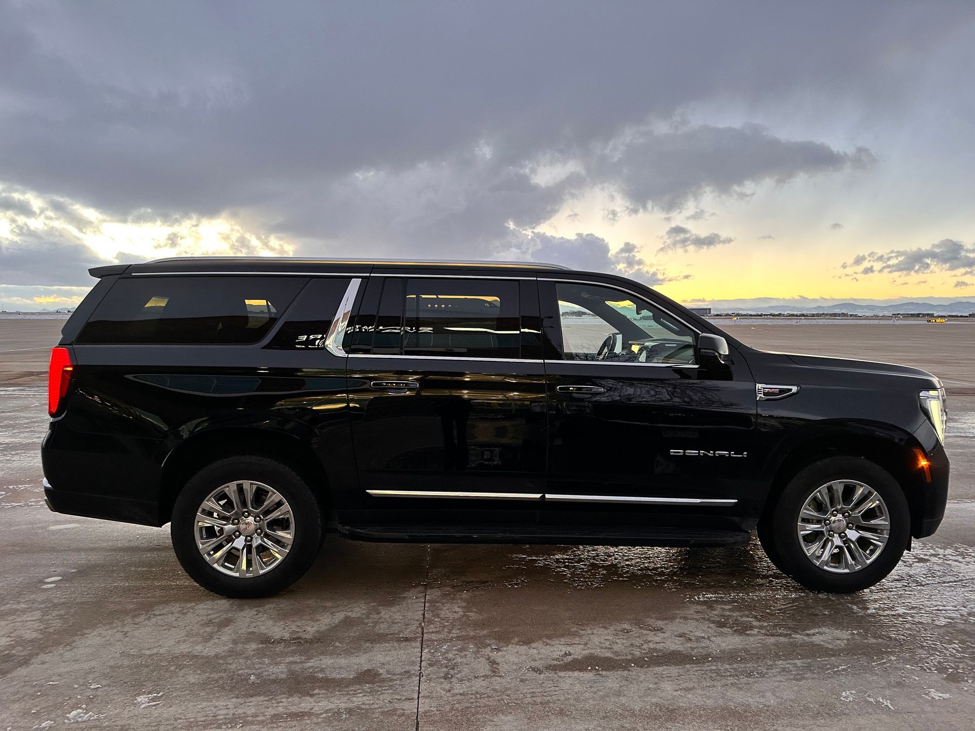 A black ford expedition is parked in a driveway next to a suburban suv.