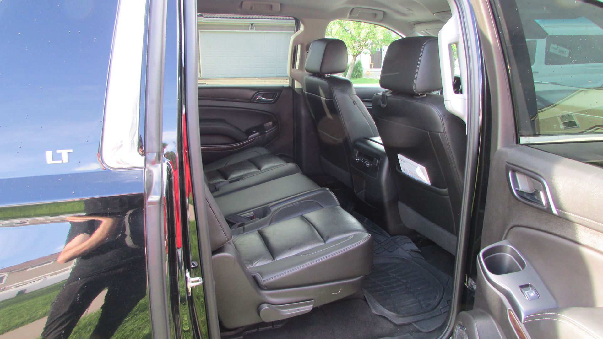 The back seat of a black suv with lt written on the door