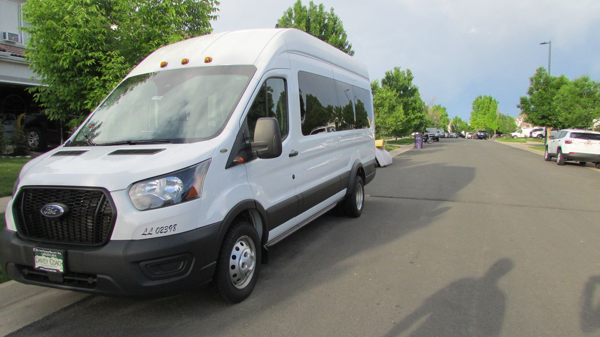 A white van is parked on the side of the road.
