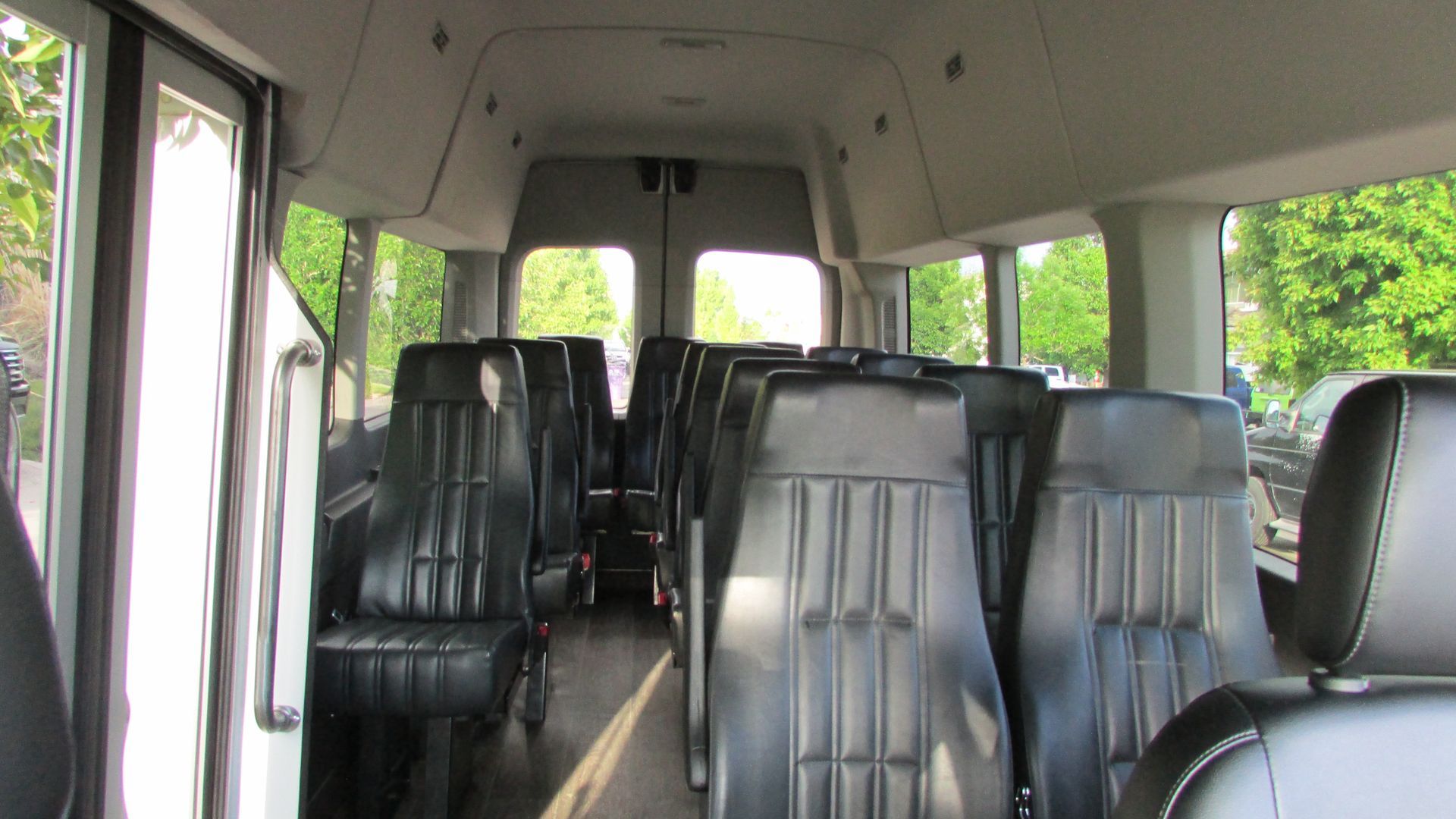 The inside of an empty van with black seats