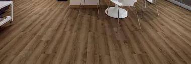 A dining room with a wooden floor and a table and chairs.