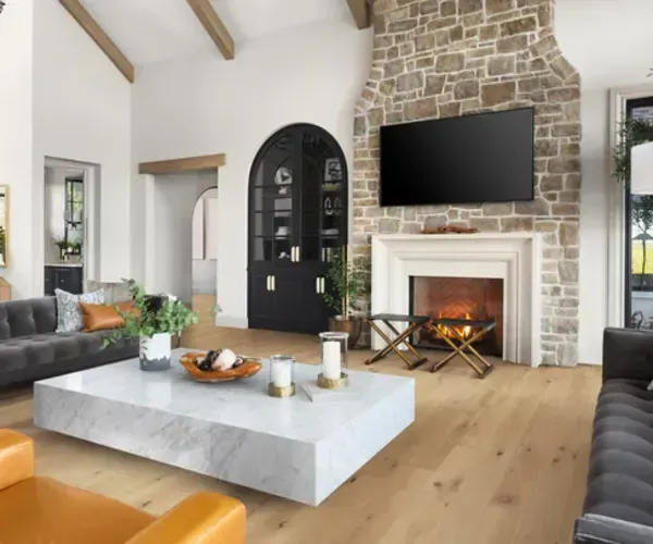 A living room with a fireplace and a flat screen tv.