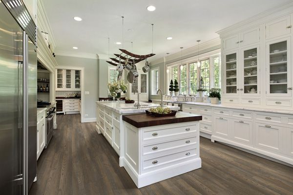 A large kitchen with white cabinets and stainless steel appliances.
