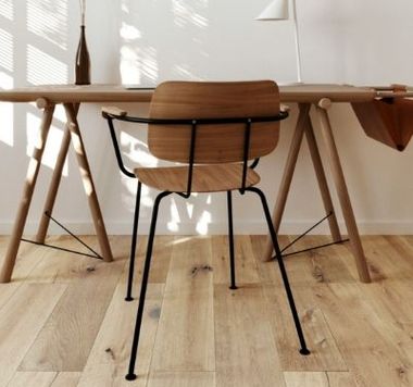 A wooden chair sits in front of a wooden desk