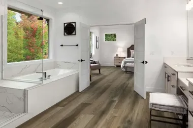 A bathroom with hardwood floors and a bathtub.