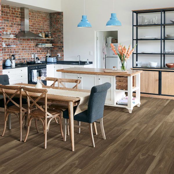 A kitchen with a table and chairs in it