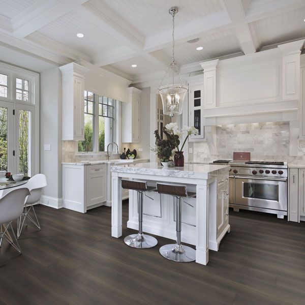 A kitchen with a large island and stools