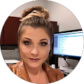 A woman is standing in front of a computer in a circle.