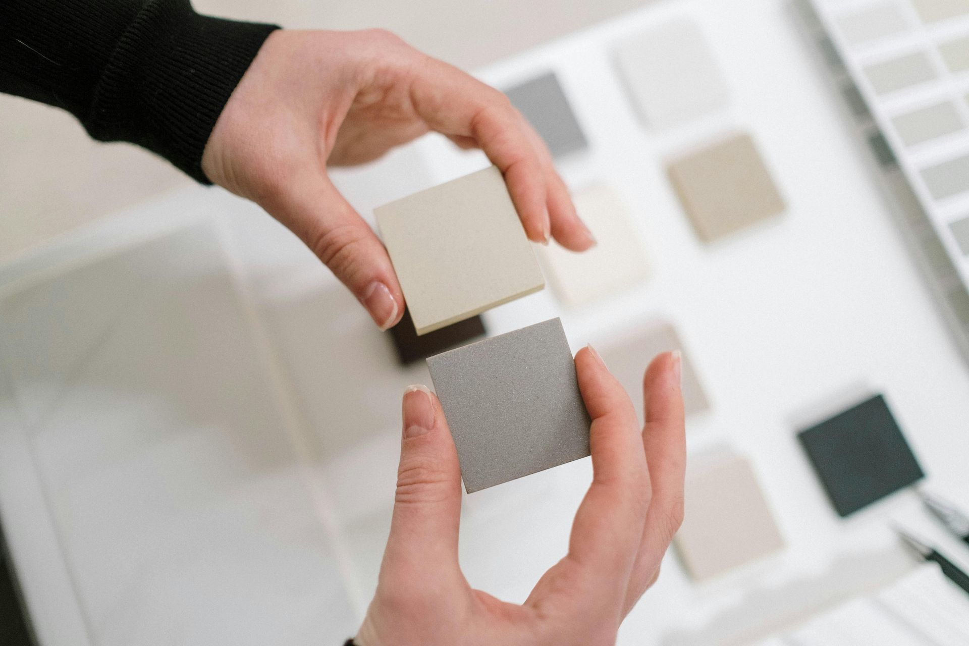 A person is holding two squares in their hands.