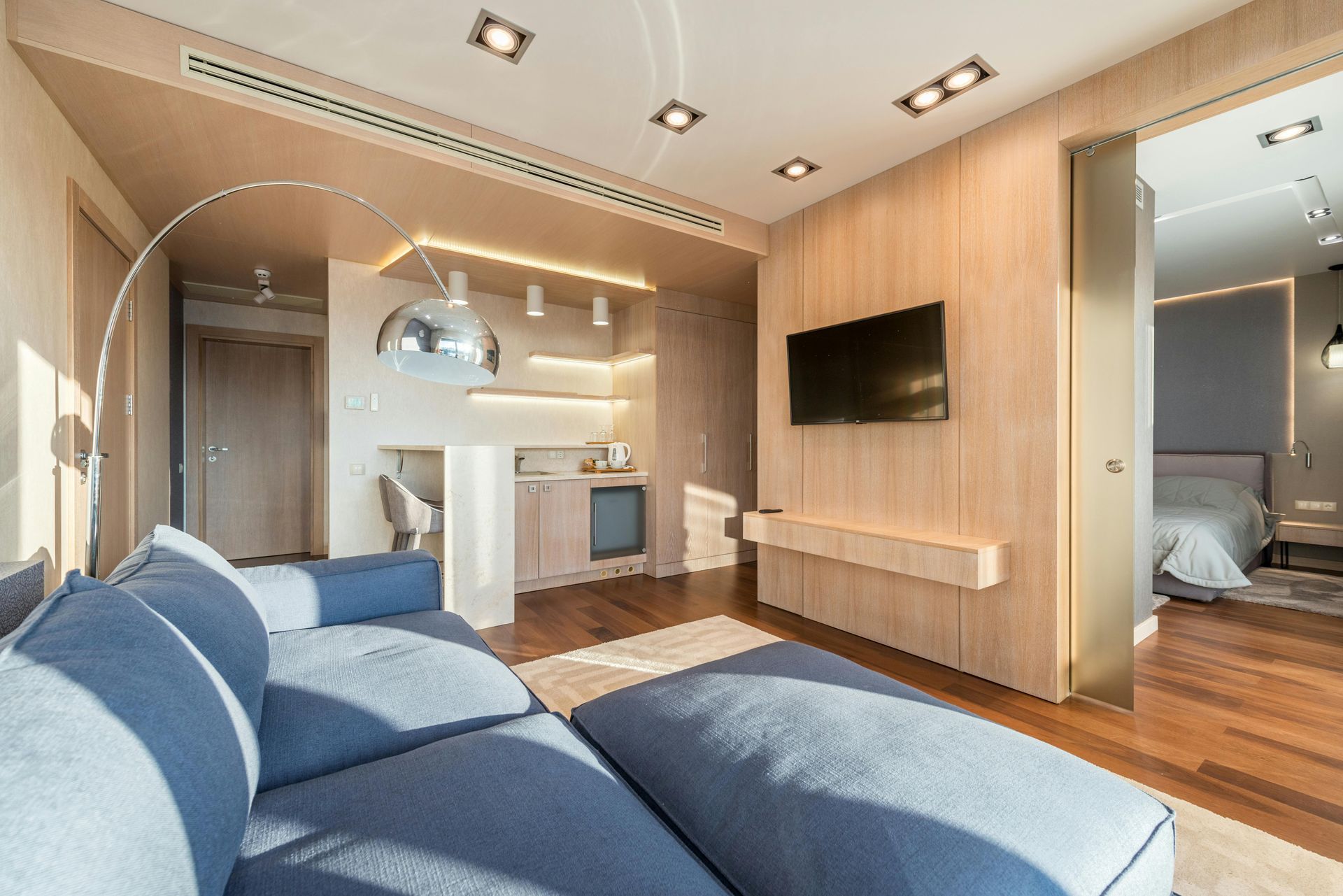 A living room with a couch and a flat screen tv.