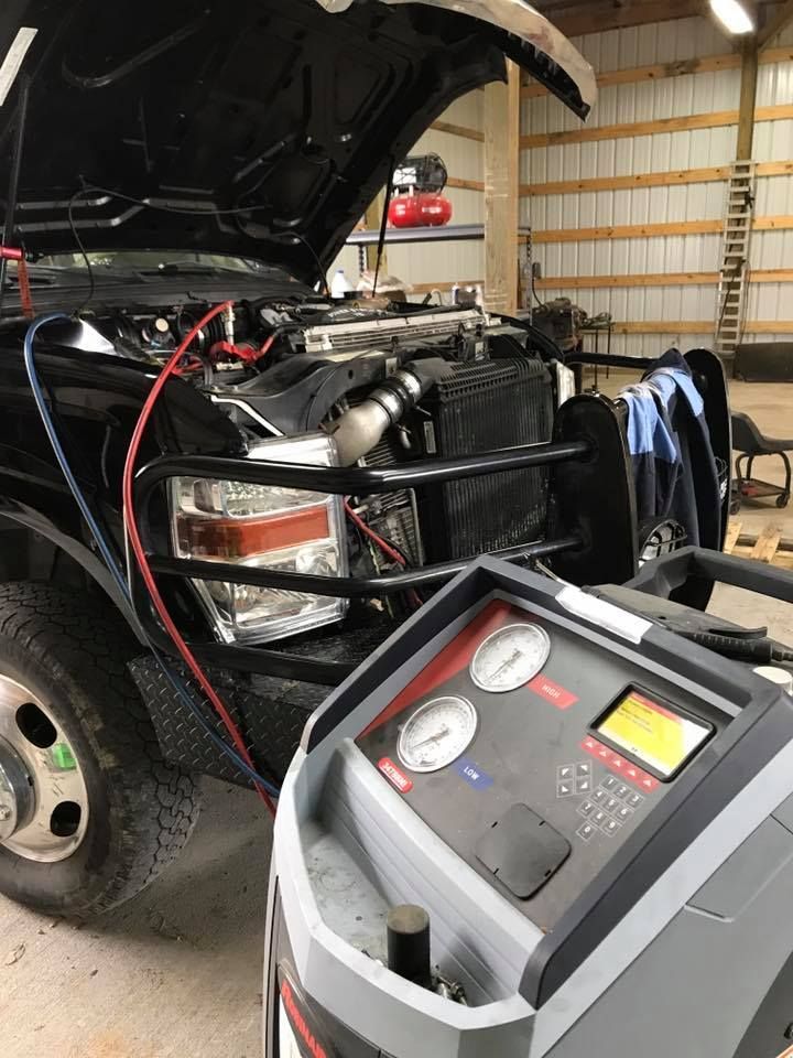 Black Ford Super Duty Truck with its Hood Open | Lowes Auto Care