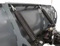 Close-up of a snowplow blade with two large black springs connected to the frame, painted gray.