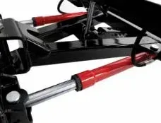 Red hydraulic cylinders on a black metal frame, likely for lifting a dump bed.