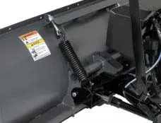 Snowplow with a large spring, attached to the blade and frame.