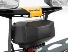 Close-up of a snowmobile. Black and yellow parts, storage box, lights. 