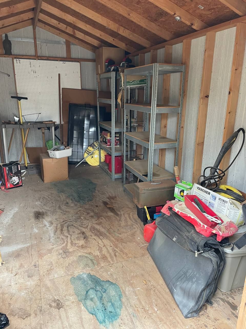 A shed filled with lots of tools and boxes