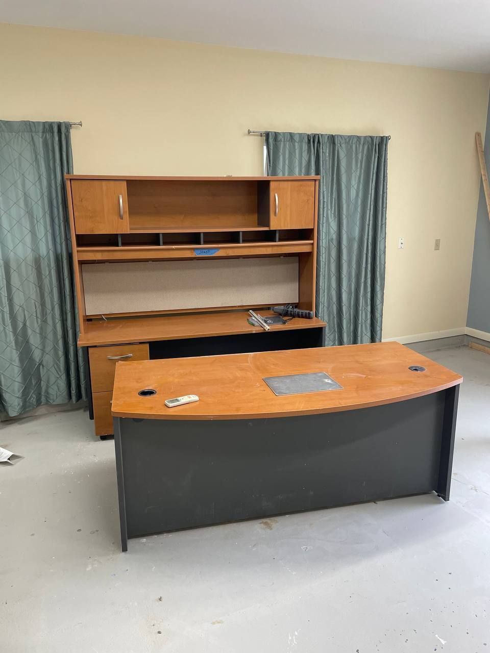 An empty room with a desk and cabinets in it