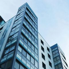 Looking up at a tall building with lots of windows