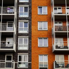 A brick building with a lot of windows and balconies