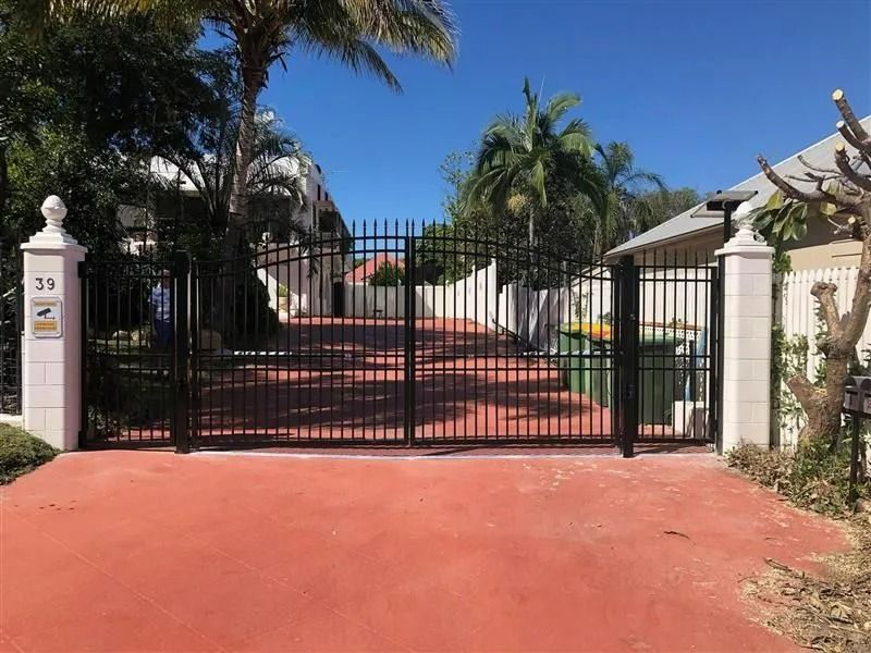Black Metal Gate Across Red Driveway, Pillars on Either Side, Street Sign on Left Pillar — Gate-O-Matic in Garbutt, QLD