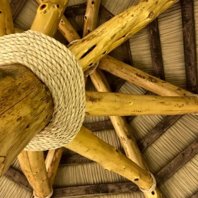 Wooden roof beams with rope detailing.